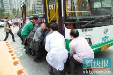 男子闯红灯双腿被压公交车下 十余路人抬车救人