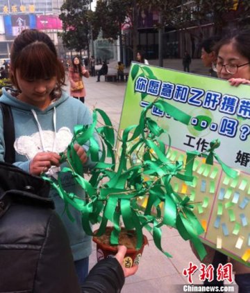 郑州市民为“枯树”系翡翠丝带 吁关爱乙肝患者